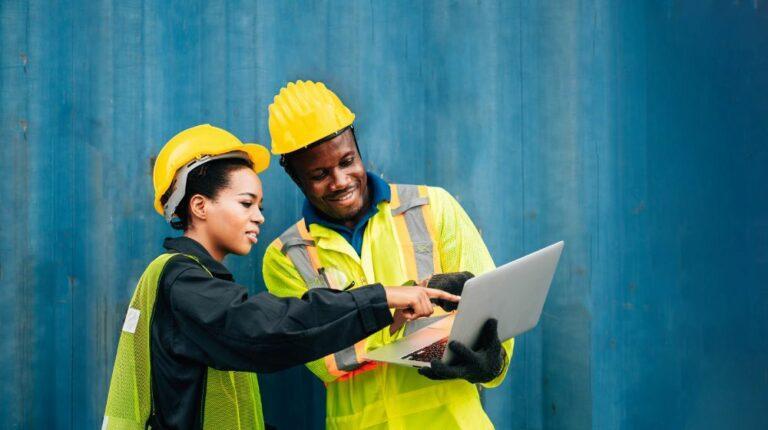 Workers looking at a laptop.